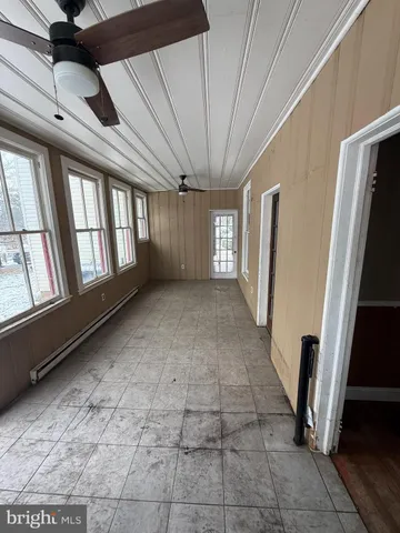 a view of a livingroom with a ceiling fan and window