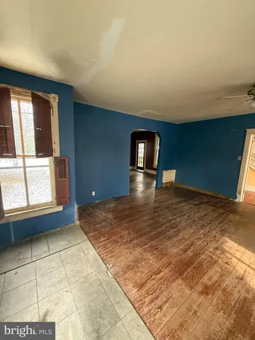 a view of a hallway with wooden floor and stairs