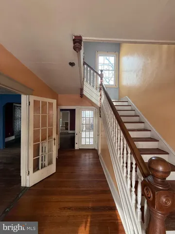 a living room with kitchen island furniture and a flat screen tv