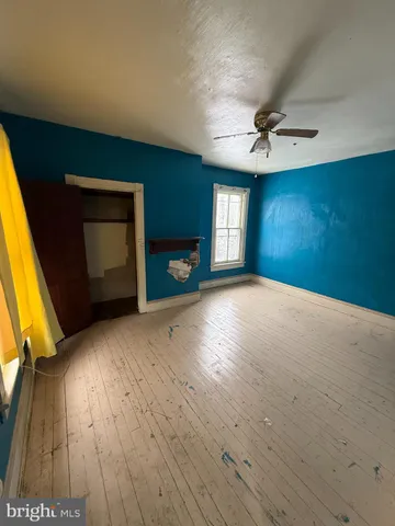 a view of a livingroom with a fireplace and a chandelier fan