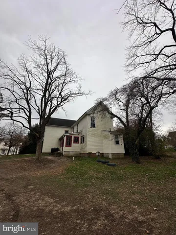 a view of a house with a yard covered in the forest