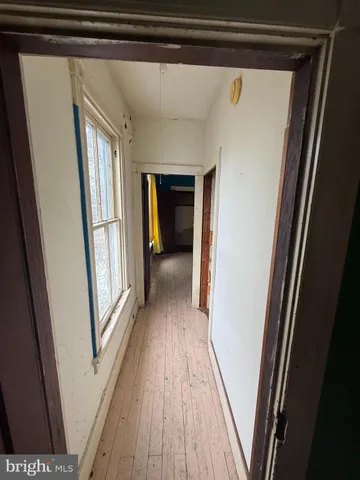 a view of empty room with ceiling fan and window