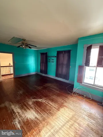a view of a room with wooden floor