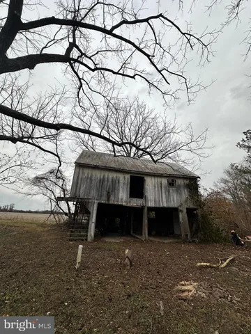 a view of a house with a yard next to a yard