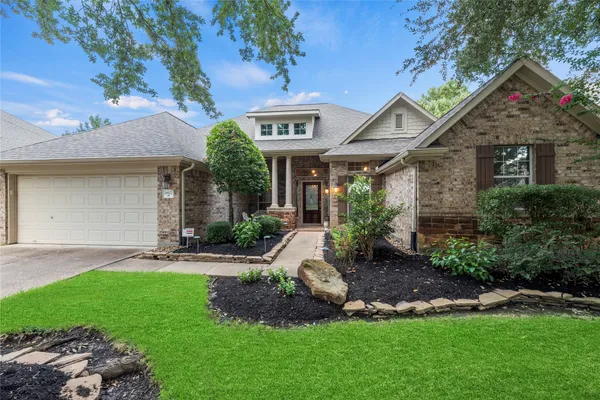 a front view of a house with a garden and plants