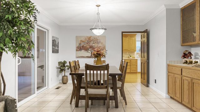 a view of a dining room with furniture and chandelier