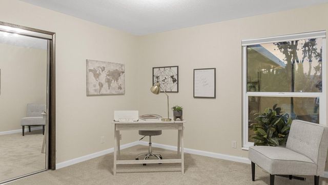 a workspace with furniture and a potted plant