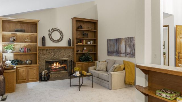 a living room with furniture and a fireplace