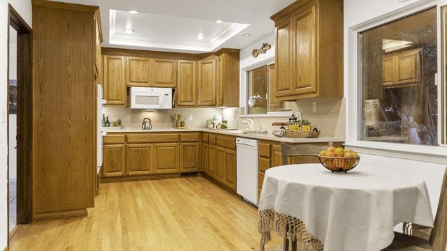 a kitchen with a sink cabinets and window