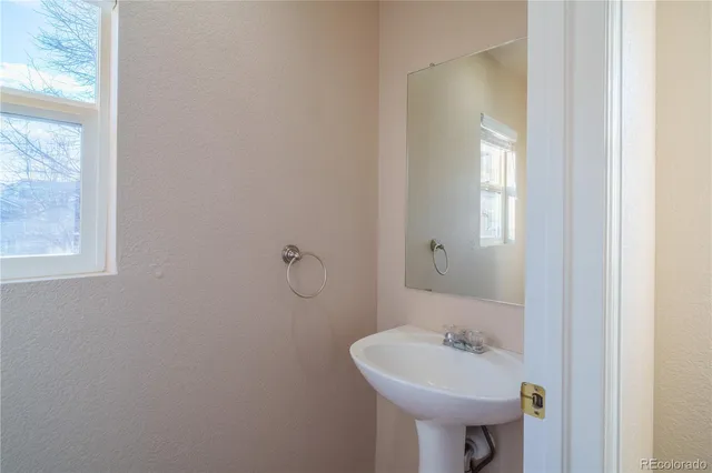 a bathroom with a sink a mirror and a toilet