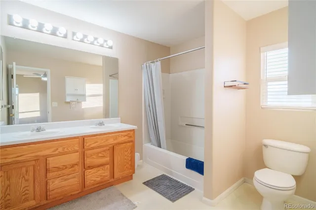 a spacious bathroom with a granite countertop sink toilet and shower