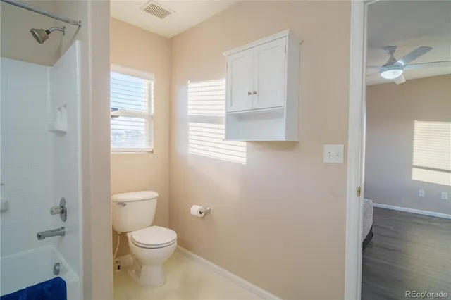 a bathroom with a toilet a sink and a window