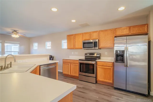 a kitchen with granite countertop a sink stainless steel appliances and cabinets