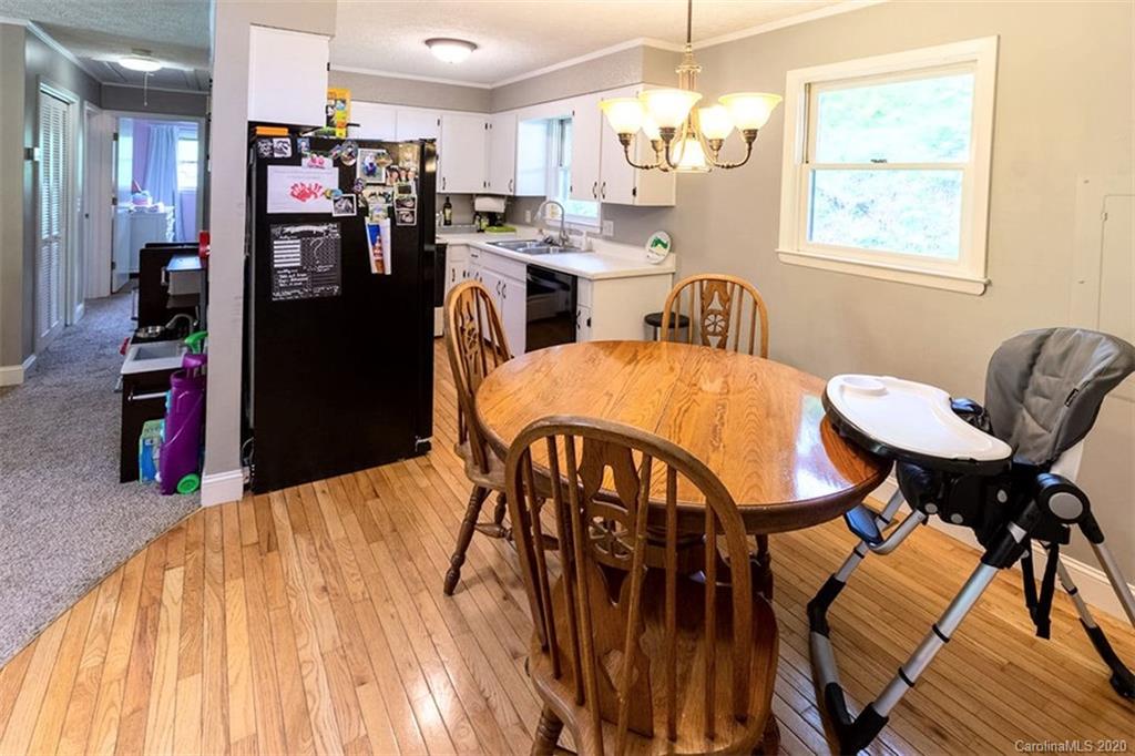 427 Kitchens Branch Road Sylva, NC 28779 - Photo 13 of 27 a open kitchen with stainless steel appliances dining table and chairs