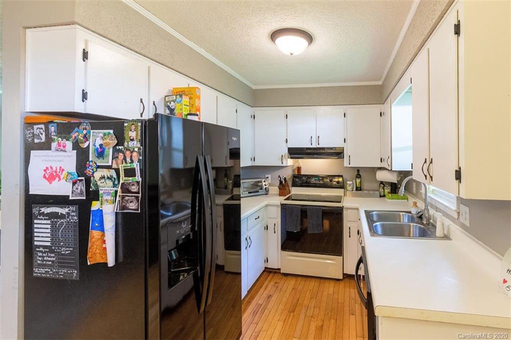 427 Kitchens Branch Road Sylva, NC 28779 - Photo 14 of 27 a kitchen with stainless steel appliances granite countertop a refrigerator stove and sink