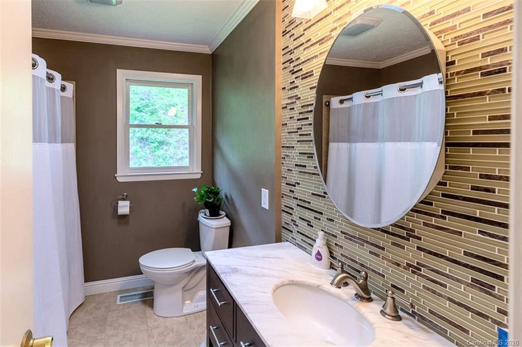 427 Kitchens Branch Road Sylva, NC 28779 - Photo 16 of 27 a bathroom with a sink a toilet and mirror