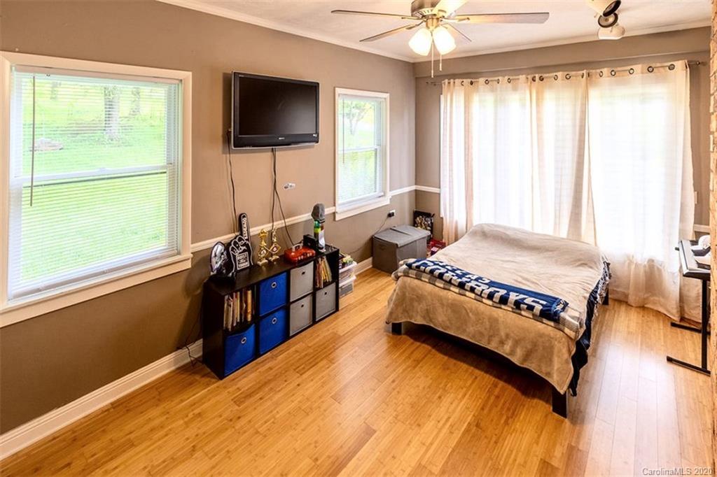 427 Kitchens Branch Road Sylva, NC 28779 - Photo 20 of 27 a bed room with a bed and a television