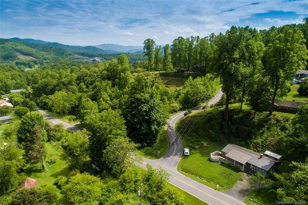 427 Kitchens Branch Road Sylva, NC 28779 - Photo 3 of 27 a view of a garden with a building in the background
