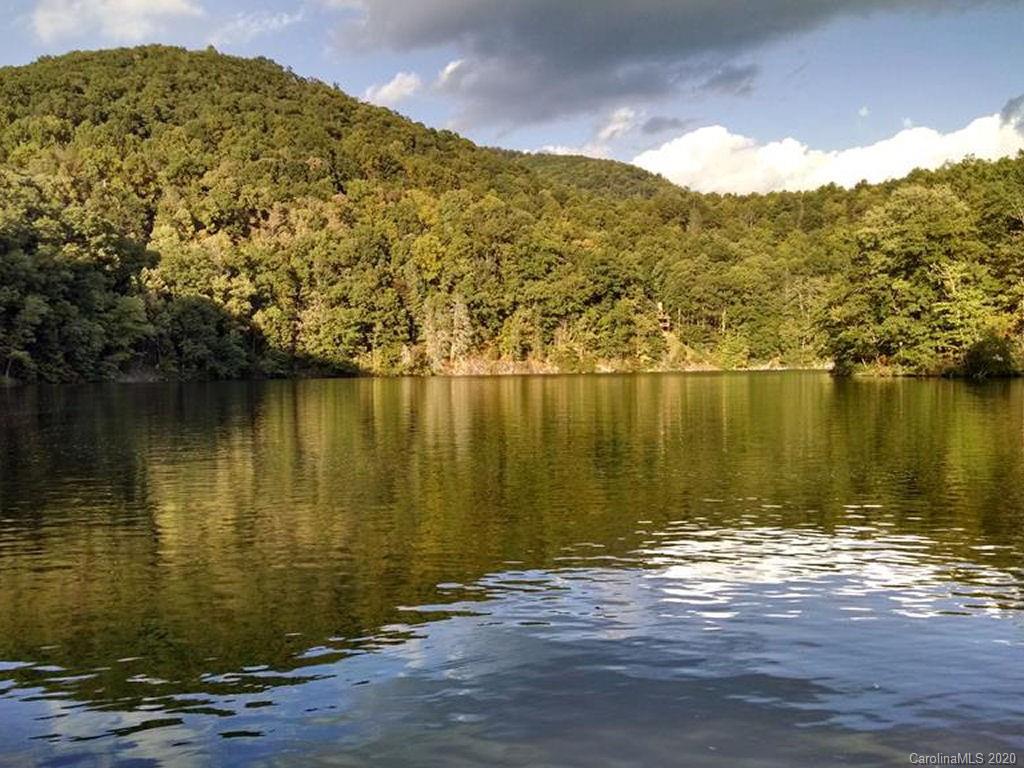 427 Kitchens Branch Road Sylva, NC 28779 - Photo 25 of 27 a view of a lake with a mountain in the background