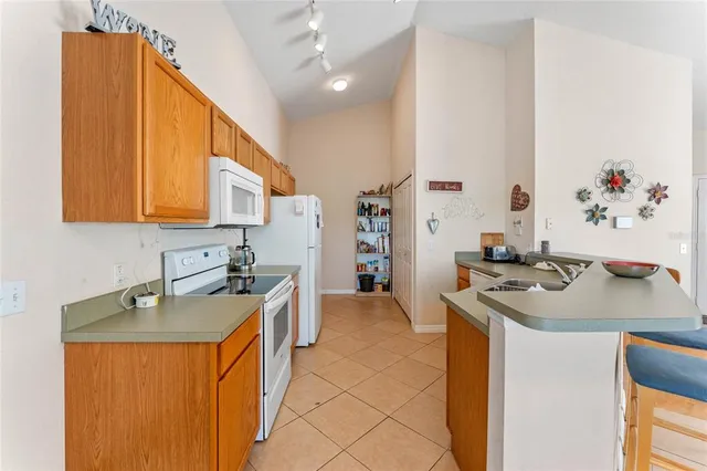 a kitchen with stainless steel appliances a sink stove and cabinets