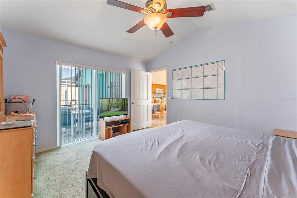 233 Reserve Drive Davenport, FL 33896 - Photo 14 of 25 a bedroom with a bed and a chandelier