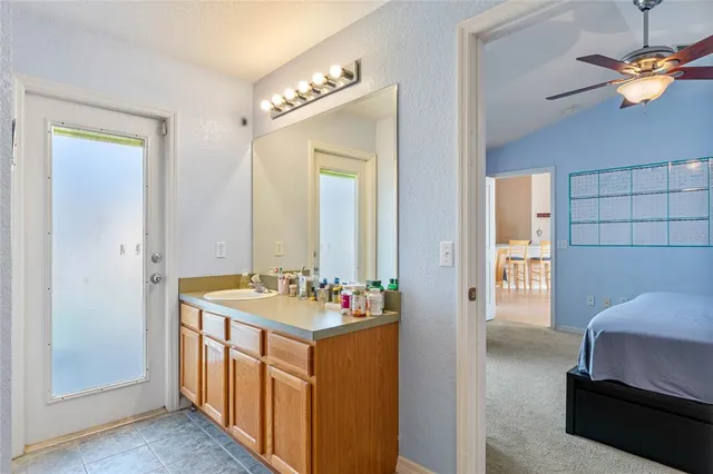 a en suite bathroom with a double vanity sink and a mirror