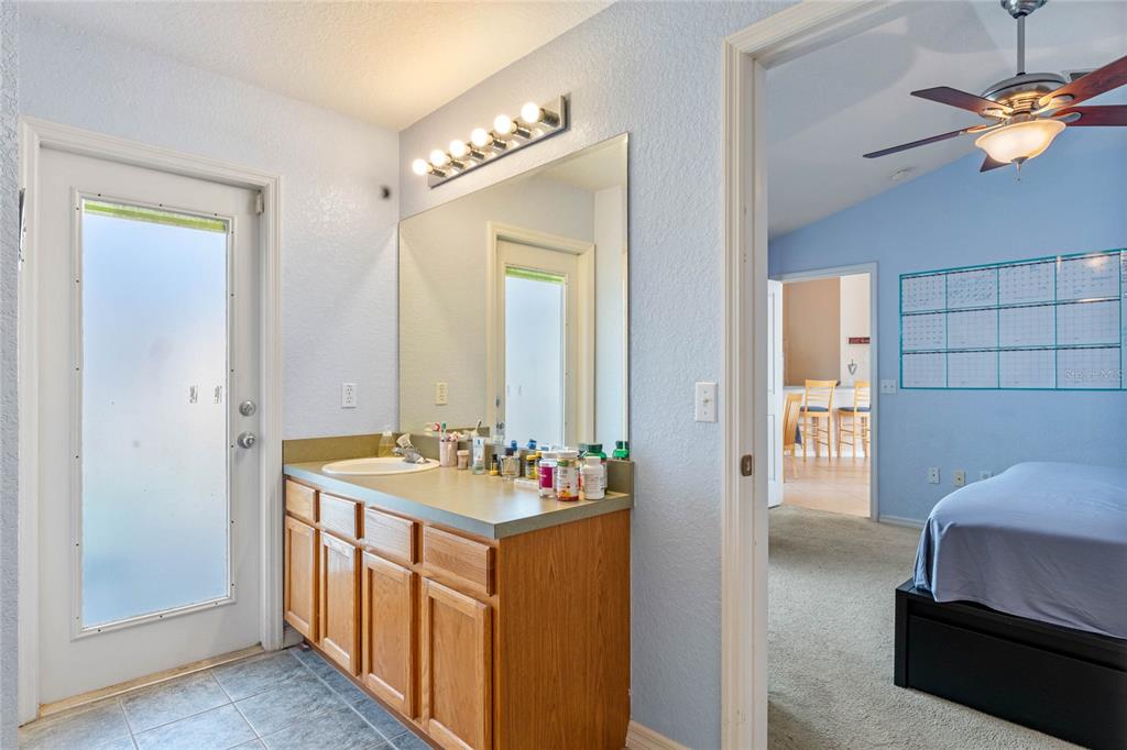 233 Reserve Drive Davenport, FL 33896 - Photo 16 of 25 a en suite bathroom with a double vanity sink and a mirror