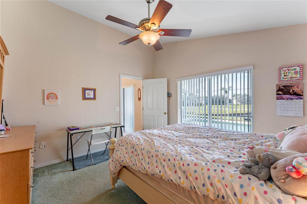 233 Reserve Drive Davenport, FL 33896 - Photo 18 of 25 a bedroom with a bed dresser and a window