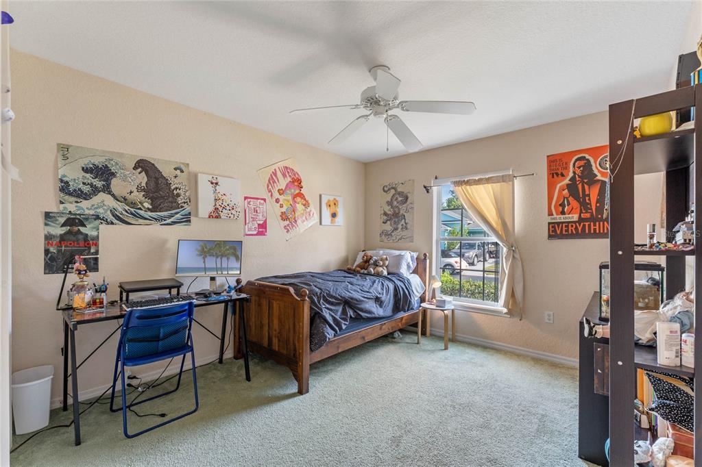 233 Reserve Drive Davenport, FL 33896 - Photo 21 of 25 a bedroom with a bed and a window