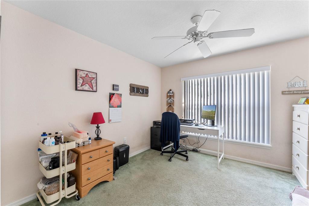 233 Reserve Drive Davenport, FL 33896 - Photo 22 of 25 a view of a workspace with furniture and a ceiling fan
