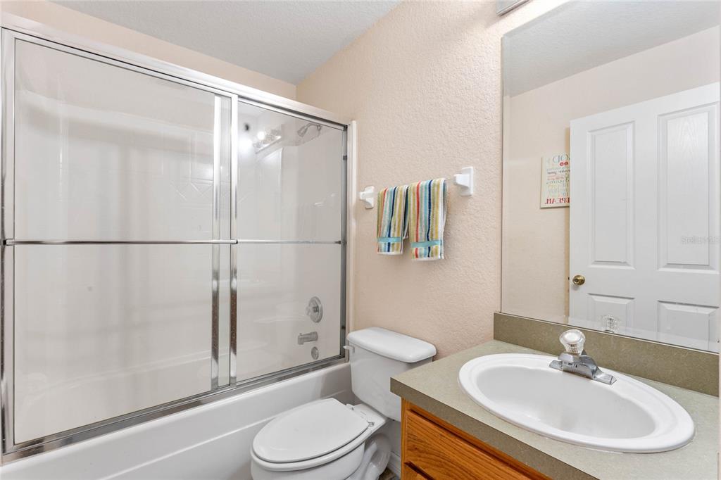 233 Reserve Drive Davenport, FL 33896 - Photo 23 of 25 a bathroom with a sink a toilet and shower