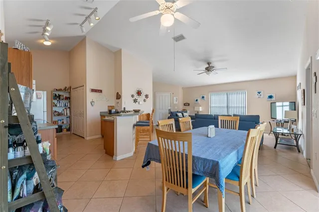 a view of a dining room with furniture and a chandelier