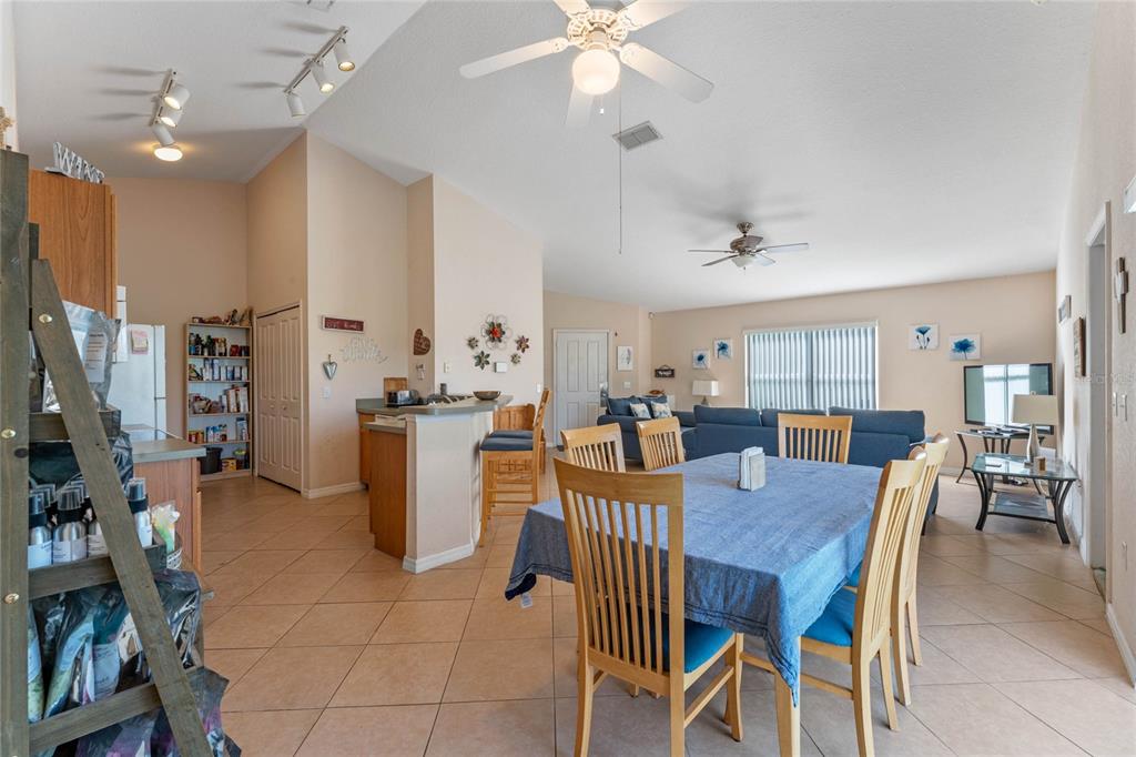 233 Reserve Drive Davenport, FL 33896 - Photo 10 of 25 a view of a dining room with furniture and a chandelier