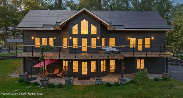 a front view of a house with a yard table and chairs