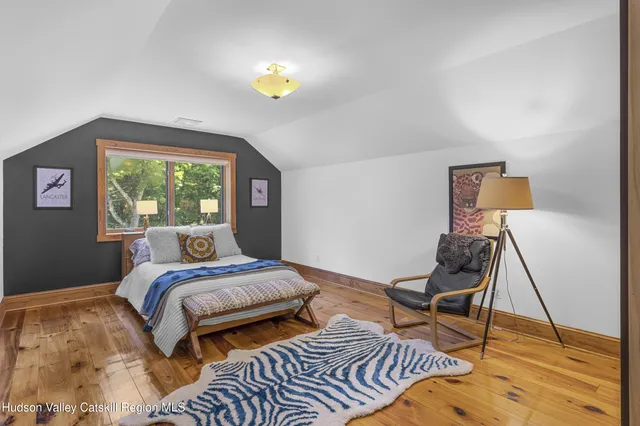 a bathroom with a granite countertop sink mirror vanity and toilet