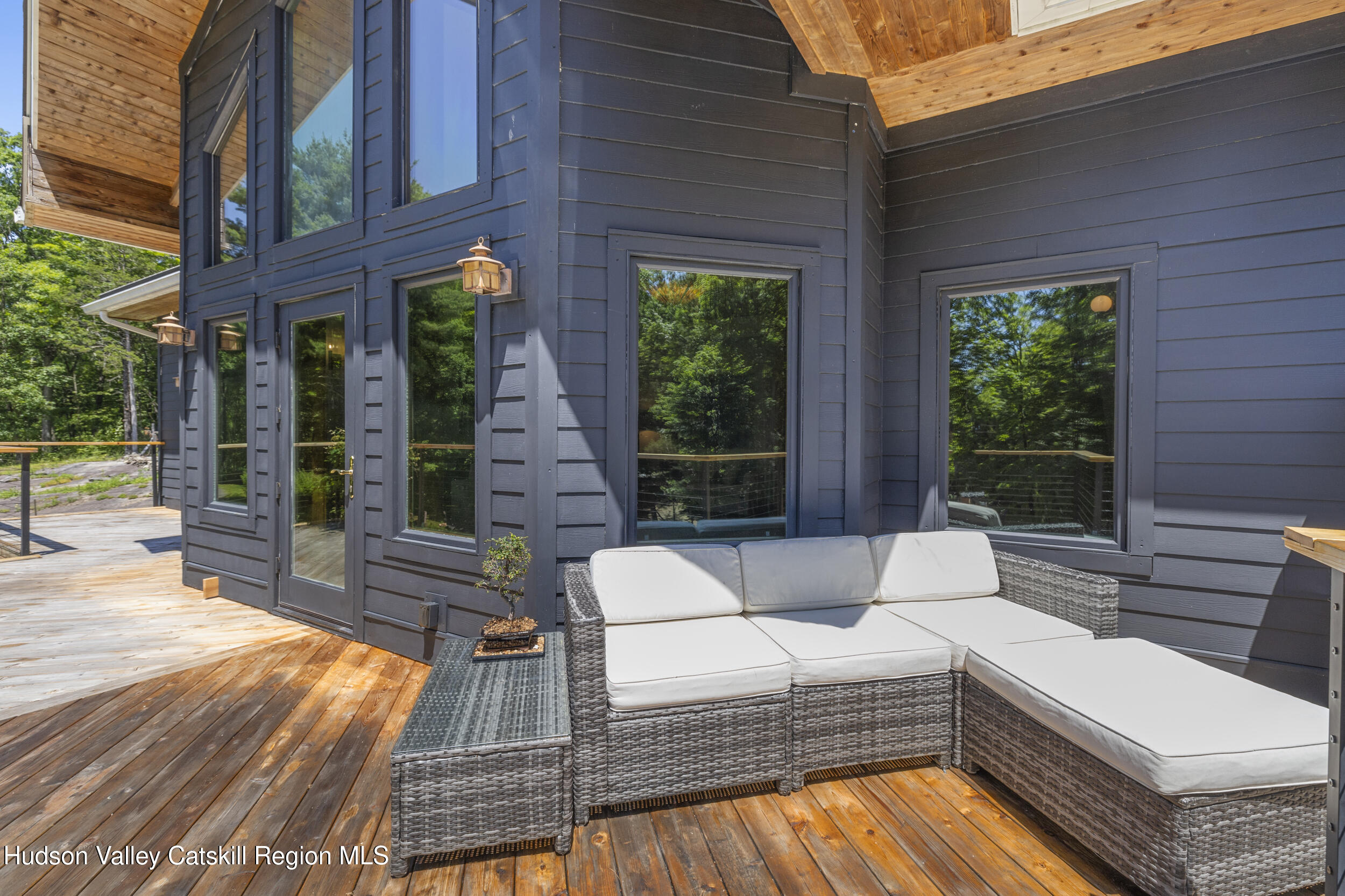 592 Swartekill Road Esopus, NY 12561 - Photo 23 of 38 a view of a patio with couches and table with wooden floor and fence