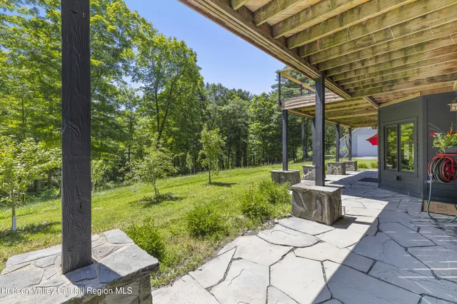a view of a house with a yard and wooden fence