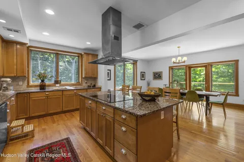 a kitchen with stainless steel appliances kitchen island granite countertop a refrigerator and microwave