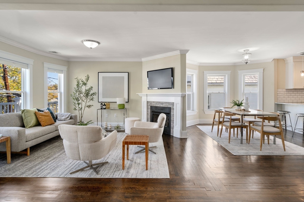 a living room with fireplace furniture and a wooden floor