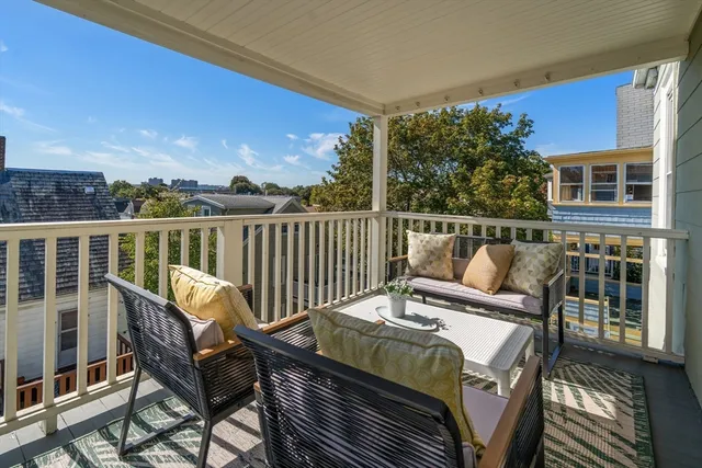 a view of a chairs and table on the roof deck