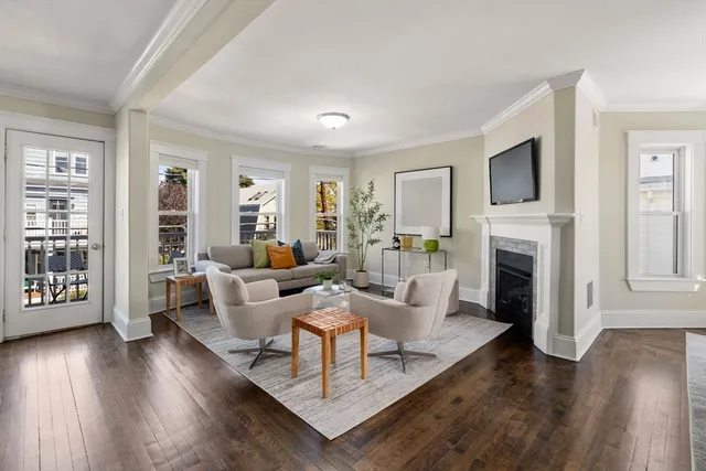 a living room with fireplace furniture and a wooden floor