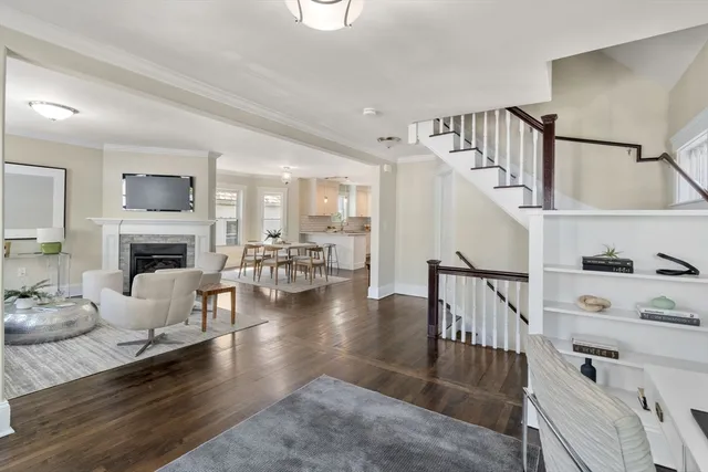 a living room with furniture and a fireplace with wooden floor