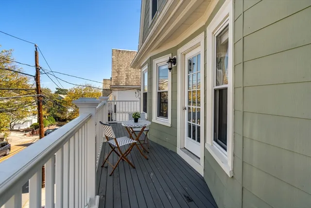 a balcony with wooden floor