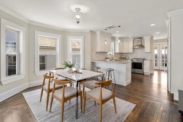 a view of a dining room with furniture wooden floor and chandelier
