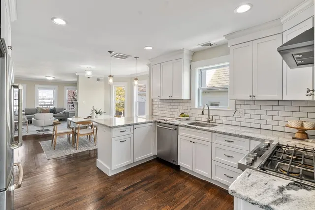 a kitchen with lots of counter top space and painting on the wall