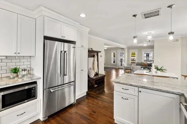 a kitchen with stainless steel appliances a refrigerator sink and microwave