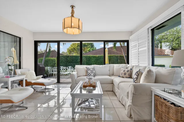 a living room with furniture a table and a large window
