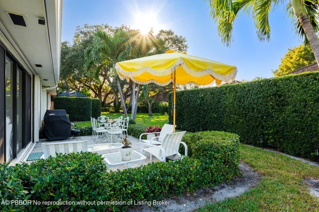 a view of a chair and table in the backyard