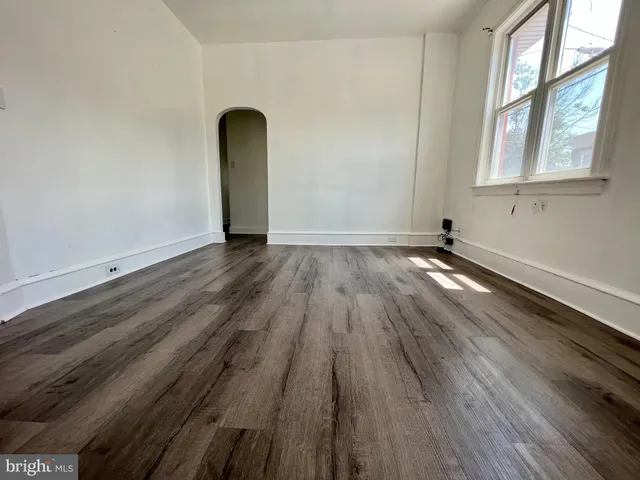 a view of a room with wooden floor and window