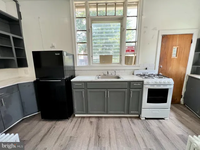 a kitchen with a sink a stove a microwave and refrigerator